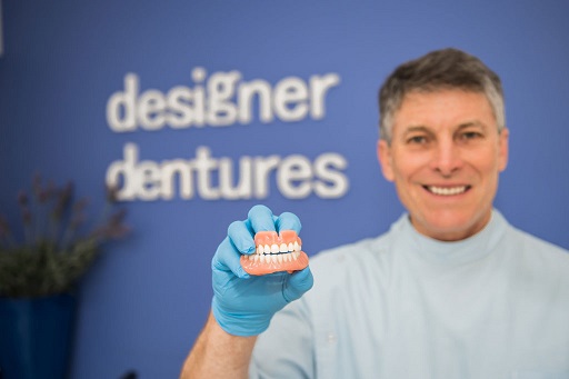 Dental prosthetist fitting custom dentures for a natural look