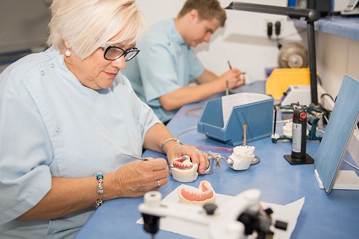 Dental technician performing a denture repair