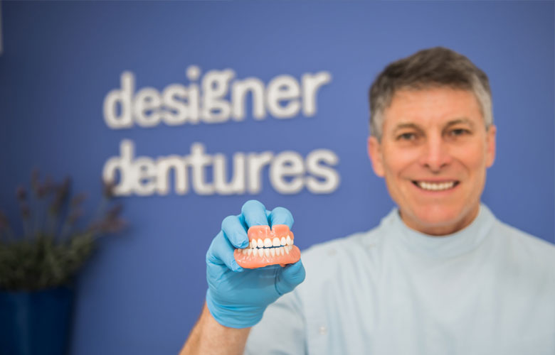 Dental prosthetist explaining denture options to a patient